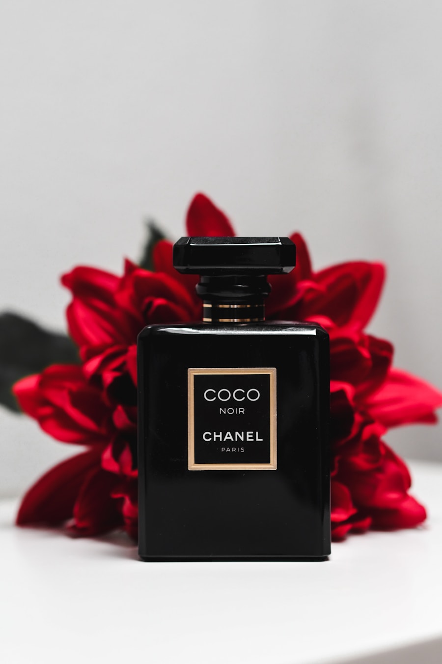 Still from a fashion film: a fragrance bottle in shadow